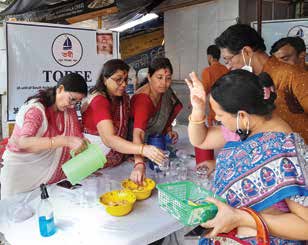 Volunteers distributing drinking water at a temple camp.
