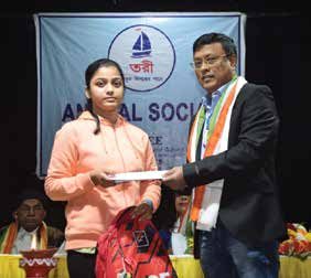 Dibyendu Barua presenting the scholarship to a student in 2022.
