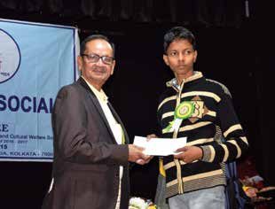Sambaran Banerjee presenting the scholarship to a student in 2023.