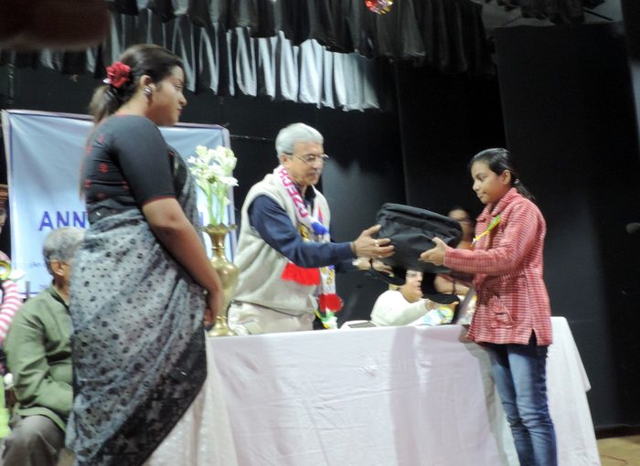 A guest presenting a scholarship award to a student.