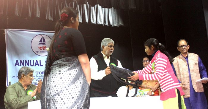 A scholarship being handed over on stage at the award ceremony.