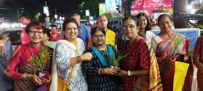 Members of TOREE holding the small plants given out on a Kolkata street during Rakhi Bandhan, August 2025.