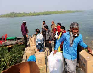 Volunteers travelling with supplies in the Sundarbans.
